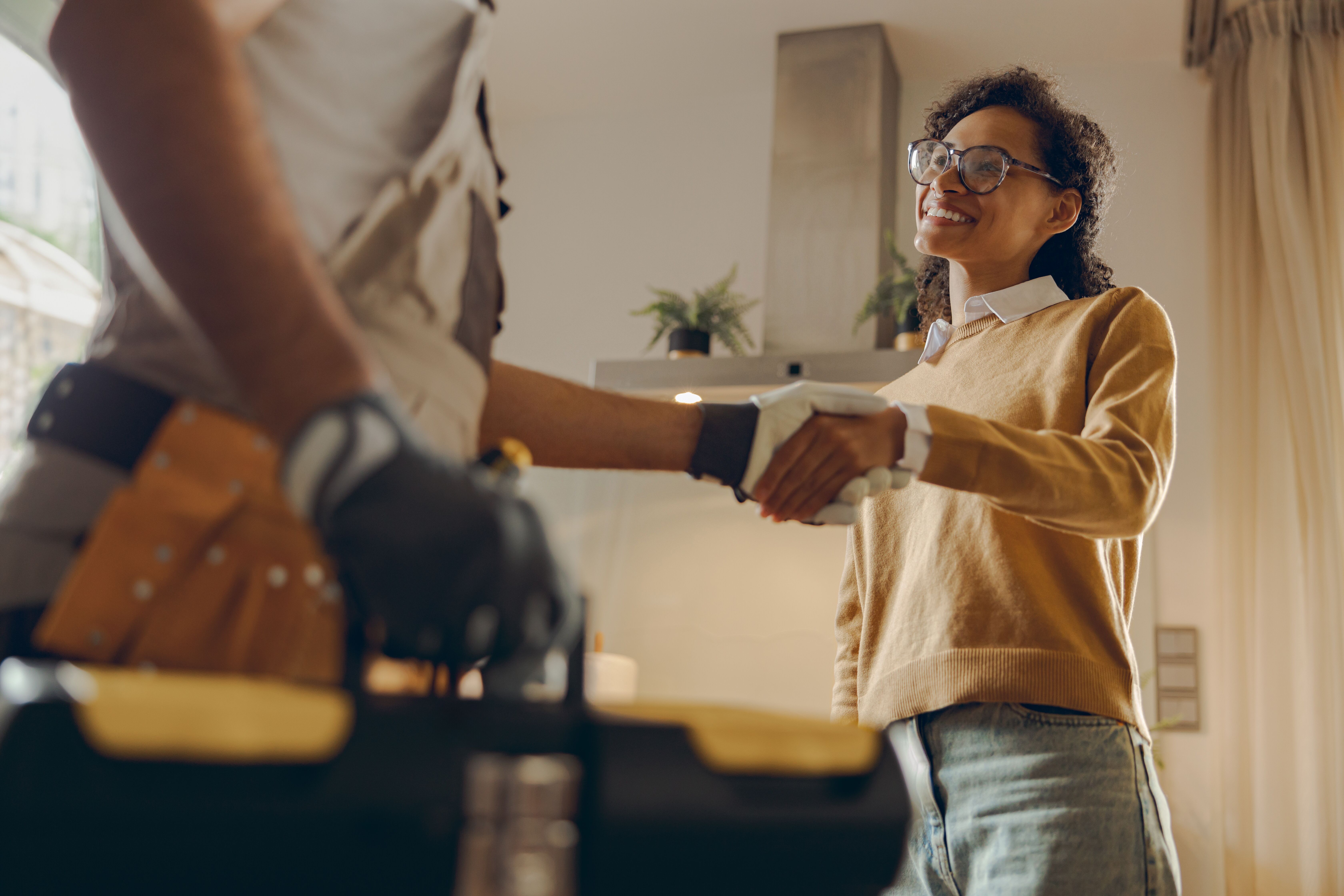 A plumber shaking hands with a happy client - WyattWorks is dedicated to customer satisfaction in Mooresville / Huntersville, NC.