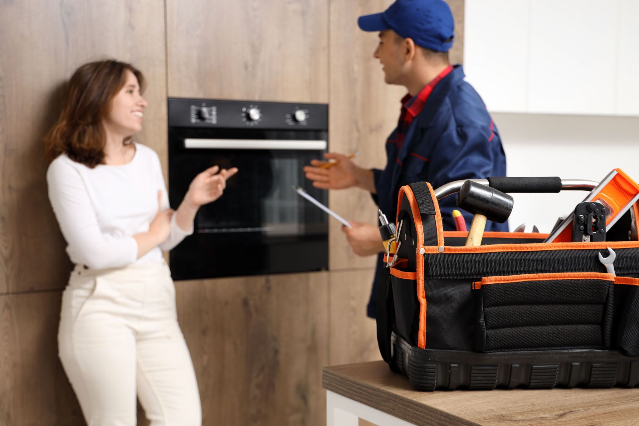 An electrician speaking with a homeowner about options regarding electrical installation in Cleveland, OH.